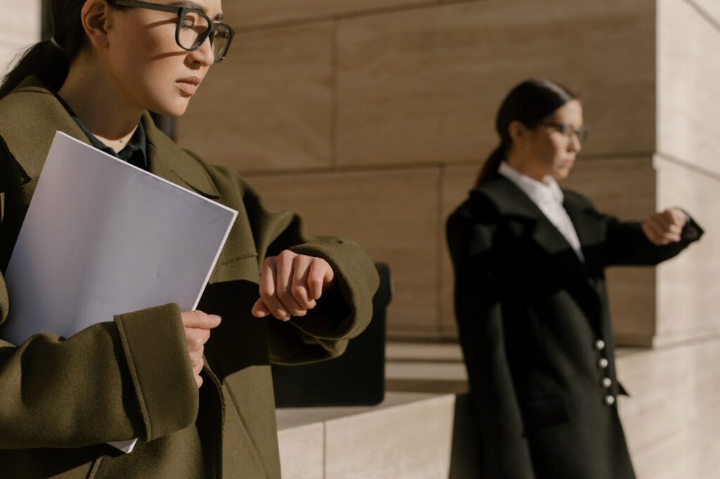 Foto de mulheres vestidas com roupas corporativas checando o tempo.
